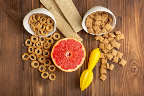 Delicious Low Carb Snacks to Curb Cravings 44 top view little cookies crackers with grapefruit brown wooden desk 140725 66051