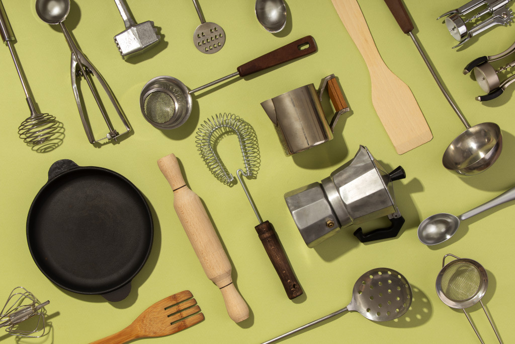 10 Must-Have Tools for a Well-Equipped Kitchen 43 top view supplies composition with green background