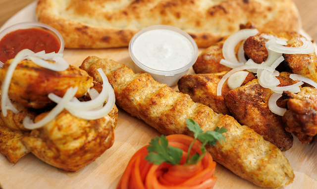 wooden plate with barbecue kebab chicken wings 2025 04 22 19 04 55 utc