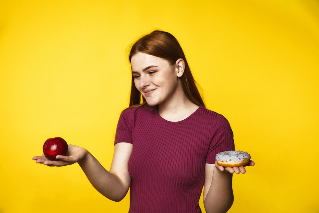 How Popular Diets Impact Your Health: What Science Says 43 young redhead girl is choosing apple donut 8353 9729