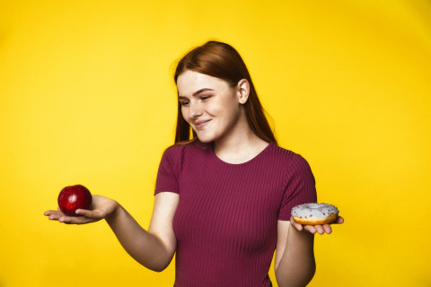 How Popular Diets Impact Your Health: What Science Says 50 young redhead girl is choosing apple donut 8353 9729